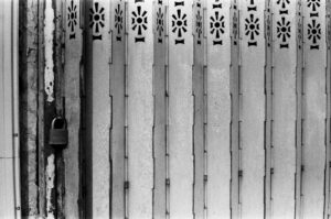 A locked metal gate with decorative patterns.